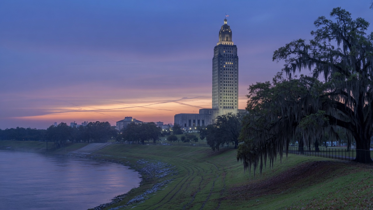 Mississippi River levee and Louisiana State Capitol at dusk